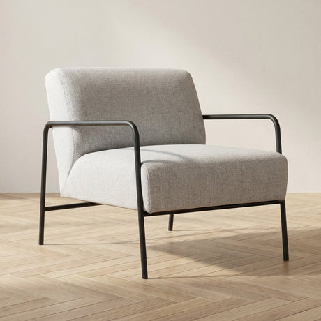 Sillón moderno de tela gris Eti - Foto atmosférica con marco negro en un interior moderno