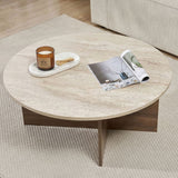 Mesa de centro redonda con tapa de travertino y base de madera oscura en forma de cruz.